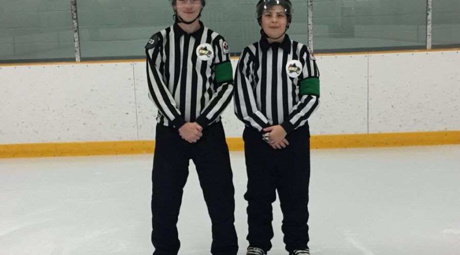 Young Hockey Officials Sport Green Arm Bands